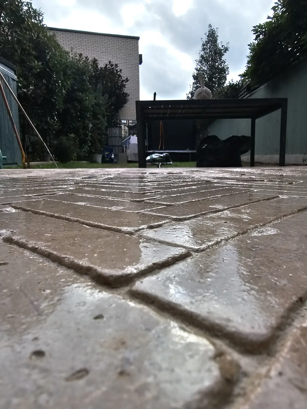 Low-angle view of sealed honed and tumbled limestone pavers with grouted joints